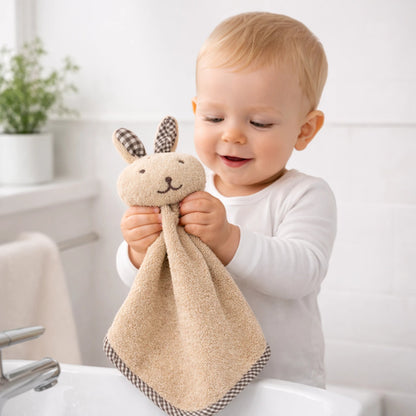 Bébé tenant une serviette lapin en microfibre, idéale pour essuyer les mains facilement