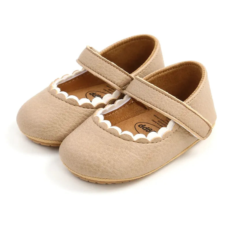 Chaussures bébé beiges en cuir naturel, confortables et sécurisées pour les premiers pas de bébé.