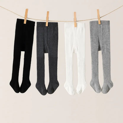 Collants bébé chauds sur corde à linge couleurs noir gris blanc pour toutes saisons