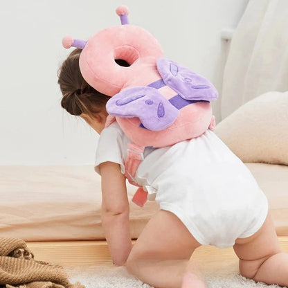 Bébé à quatre pattes avec coussin anti chute papillon rose pour protéger la tête et le dos
