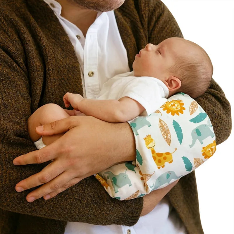 Papa berce bébé avec coussin d’allaitement imprimé jungle