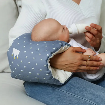 Maman nourrit son bébé avec coussin d’allaitement confortable