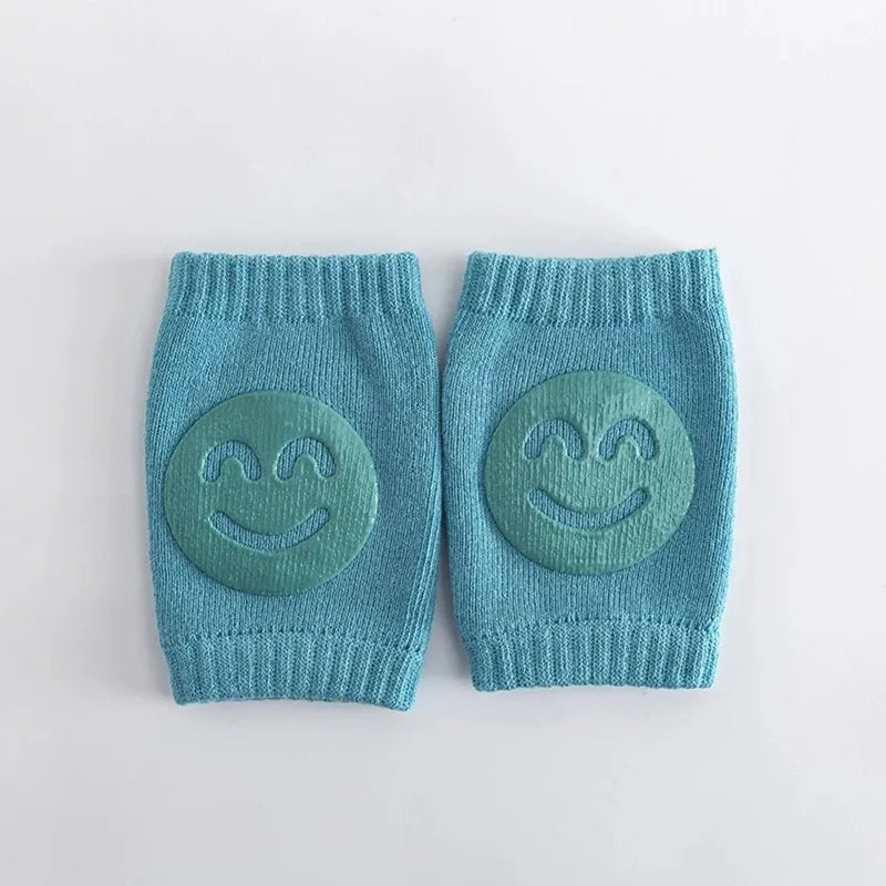 Genouillère bébé bleue antidérapante avec motif sourire pour premiers pas