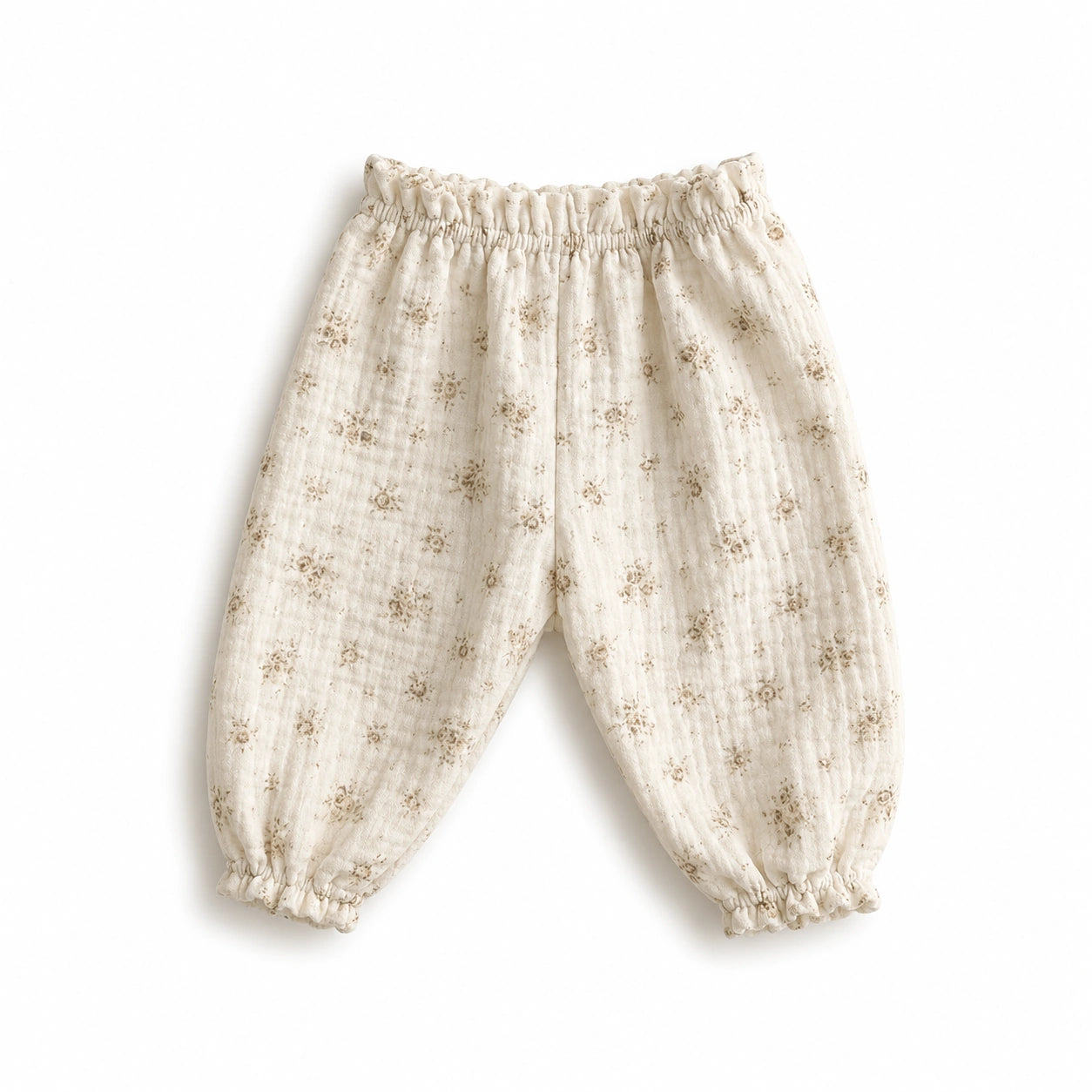 Pantalon bébé en gaze de coton à fleurs sable.