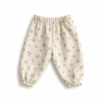 Pantalon bébé en gaze de coton à fleurs sable.