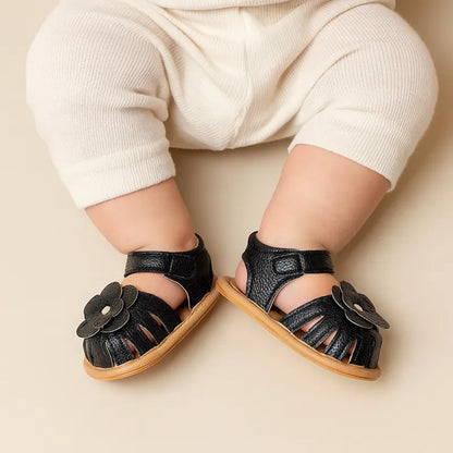 Sandales noires pour bébé avec fleur en cuir et semelle souple